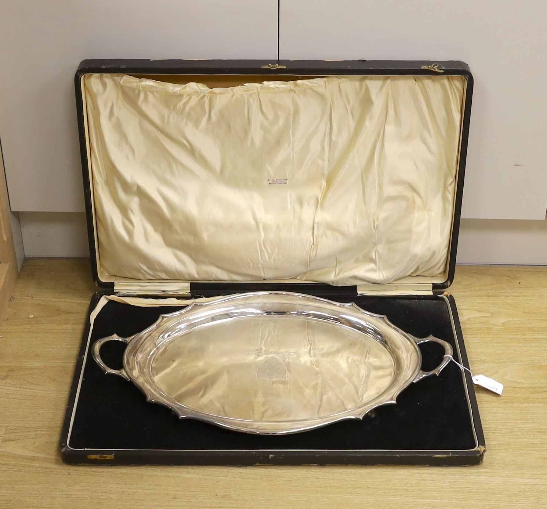 A cased George V silver two handled tea tray, with engraved inscription and crest, Synyer & Beddoes, Birmingham, 1928, 61.2cm, 79oz.